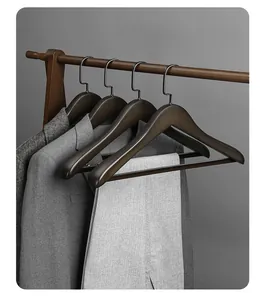 Professional wide shoulder beech wood clothes hangers displaying suits in a modern closet