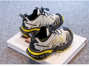 Detail view of breathable children's hiking shoes with toggle laces and yellow accents