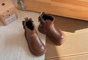 Brown leather girls' Martin boots with pom-pom trim and back bow detail