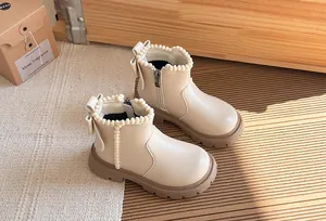 Elegant cream girl's British style Martin boots with pearl trim and back bow details.