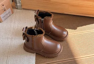 Brown girls' leather ankle boots with pom-pom trim and back bow detail