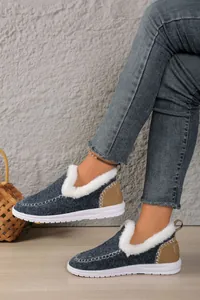 Side view of blue faux fur-lined warm snow boots with decorative tan heel stitching