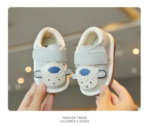 Dettaglio di scarpe primi passi grigie per neonati con pecora e velcro