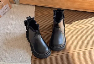 Elegant black children's British style leather boots with bow detail and ribbed collar