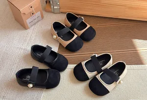Three pairs of elegant children's Mary Jane shoes in classic black and beige tones