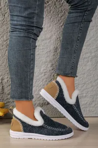 Women's cozy navy blue flat snow boots with white faux fur lining and tan heel accents.