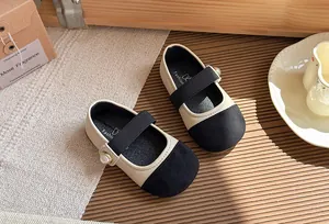 Detailed view of French style girl's Mary Jane shoes with soft sole and pearl decoration