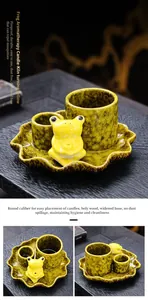 Detail of yellow kiln-glazed ceramic incense burner with cute frog figurine on lotus leaf