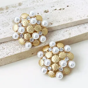 Close-up of vintage sunflower stud earrings featuring pearls and sparkling rhinestones