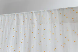 Detail of white cotton curtain with delicate orange floral print texture