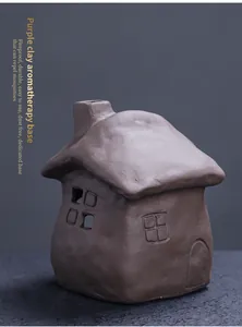 Handmade purple clay incense burner in a charming cottage house design with chimney