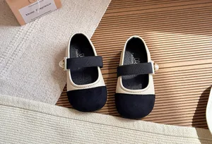Detailed top view of girls' French style Mary Jane shoes with pearl and black toe