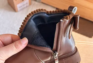 Close-up of warm plush lining and metal zipper on children's leather Martin boots