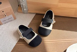 Chic beige and black girl's Mary Jane shoes with elegant pearl strap detail design