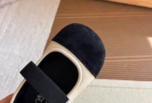 Close-up detail of girls' beige and black Mary Jane shoes with soft sole