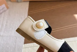 Detail of girls' cream Mary Jane shoe with elegant pearl button and velcro strap