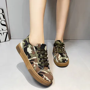 Detailed macro shot of women's camouflage canvas shoes with durable tan rubber soles