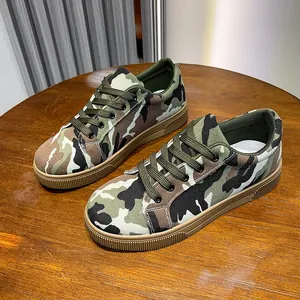 Detailed macro view of women's woodland camouflage canvas flat casual shoes on wooden surface