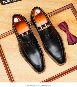 Macro view of black genuine leather loafers featuring a distinctive metal buckle design