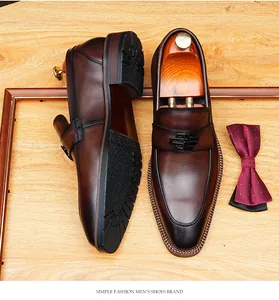 Premium brown leather loafers for men featuring a stylish metal buckle and slip-on design