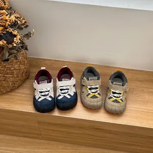Multiple color options of children's fleece-lined winter sneakers on wooden steps