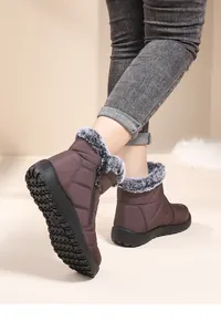 Detail view of women's non-slip snow boots with faux fur lining and side zipper