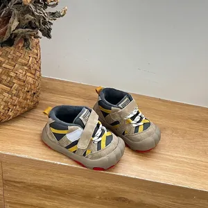 Close-up view of warm fleece-lined children's winter sneakers on a wooden surface