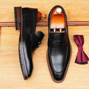 Elegant black leather loafers for men featuring a stylish metal buckle and classic design.