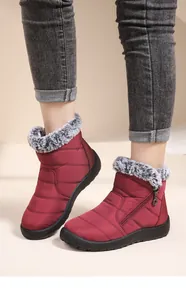 Detailed view of women's waterproof maroon snow boots with grey faux fur lining