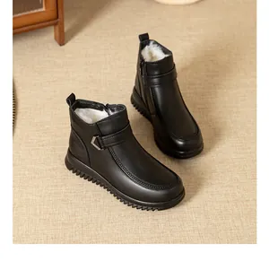 Close-up of black winter ankle boots with thick white faux fur lining and soft flat soles.