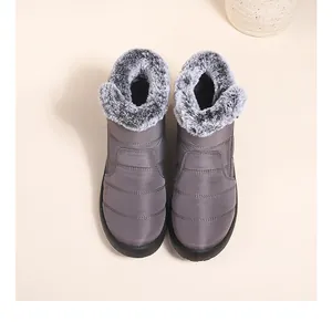 Detailed view of grey waterproof snow boots with fluffy faux fur lining.