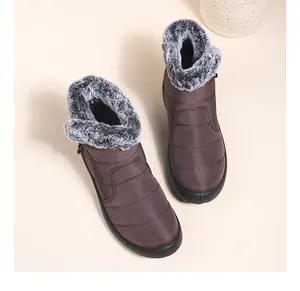 Top view of brown waterproof women's snow boots with fluffy gray faux fur trim