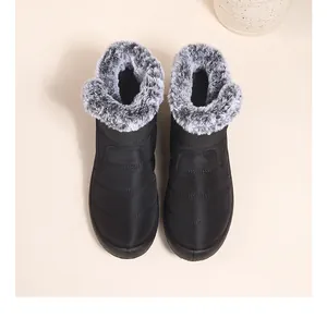 Top view of black waterproof snow boots with grey faux fur trim for winter warmth.
