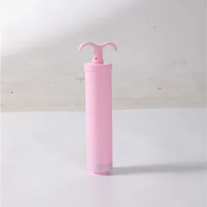 Pink manual air pump for vacuum storage bags, minimalist design on white background