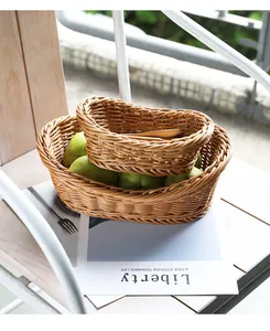 Detailed view of woven imitation rattan fruit baskets on a patio table with fresh pears