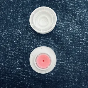 Detailed macro shot of white vacuum storage bag valve cap and pink silicone gasket