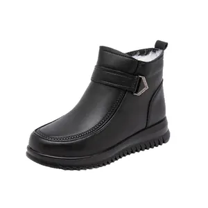 Black leather winter boots for women with warm white fur lining and non-slip sole.