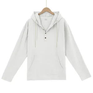 Detail of white linen hooded Henley shirt showing wooden buttons and kangaroo pocket