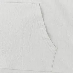 Close-up of breathable linen fabric and pocket stitching on men's hoodie