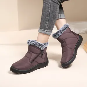 Warm women's brown winter snow boots with gray fur trim and waterproof quilted upper