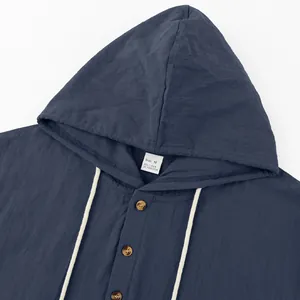 Detail shot of navy blue men's linen hooded Henley shirt with buttons and drawstring