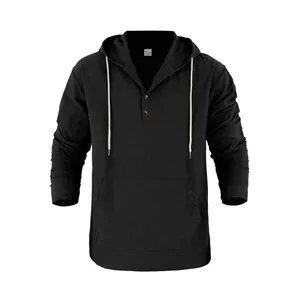 Detail of a men's black linen hooded Henley shirt featuring a kangaroo pocket and white cords