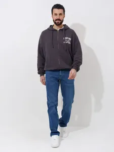 Detail view of men's straight-leg loose casual blue jeans for summer wear