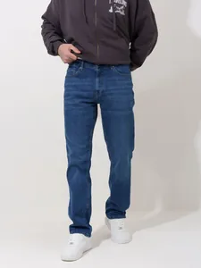Full view of men's summer thin blue jeans in a loose straight-leg casual fit on model
