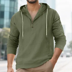 Macro view of olive green linen hooded Henley shirt with functional kangaroo pocket
