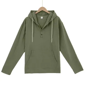 Close-up of olive green hooded Henley shirt with buttons and kangaroo pocket
