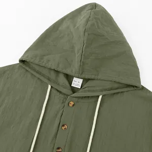 Detail view of green linen hooded Henley shirt with buttons and white drawstring