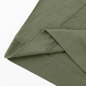 Detailed close-up of army green linen fabric and hem stitching for men's Henley shirt