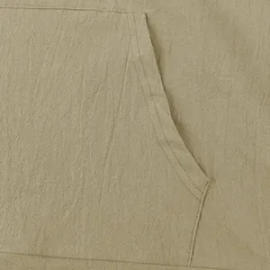 Close-up of linen fabric texture and pocket stitching on casual khaki Henley shirt