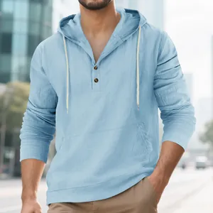 Detailed view of light blue linen hoodie for men featuring buttons and drawstring